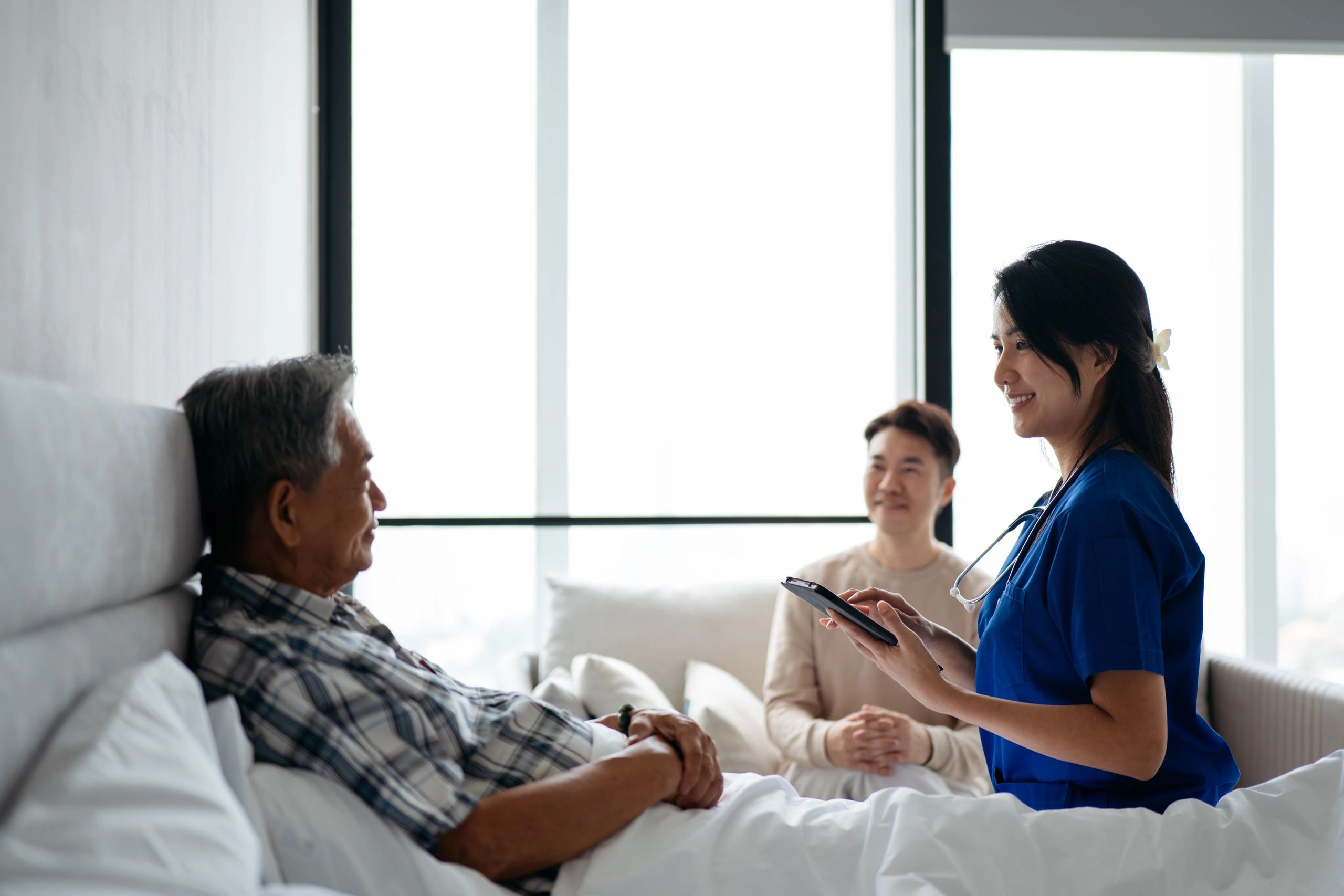 Caring nurse with seniors at MDMK Care